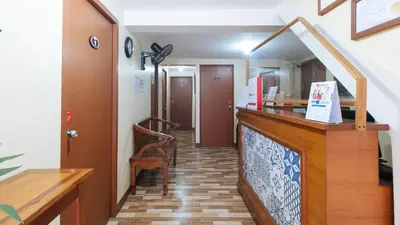 a hallway with a counter and a mirror in a room at RedDoorz near PNR Espana Station in Manila