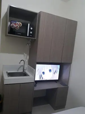 a small kitchen with a tv and a sink at Edsa Urban Deca Tower Condo Unit with Wifi and Netflix in Manila