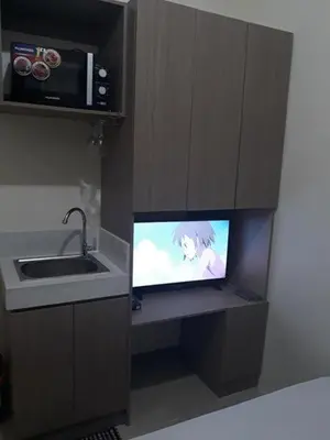 a small tv in a kitchen with a sink at Edsa Urban Deca Tower Condo Unit with Wifi and Netflix in Manila