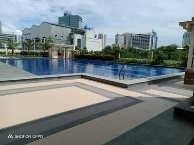 a swimming pool with a city skyline in the background at Juja's place in Manila