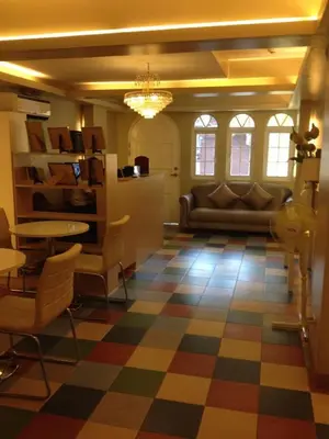 a living room with a couch and a checkered floor at ANNELENA INN in Manila