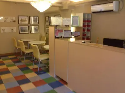 a waiting room with a counter and a table and chairs at ANNELENA INN in Manila