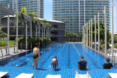a group of people sitting in a swimming pool at Azure C2 Balcony wifi Near Mall Airport MULTIPLE UNITS in Manila