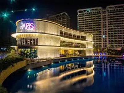 a large building with a sign on it at night at Azure C2 Balcony wifi Near Mall Airport MULTIPLE UNITS in Manila