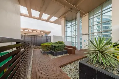 an indoor courtyard with plants in a building at Modern Stylish Condo in Morgan Suites McKinley with Wi-Fi in Manila