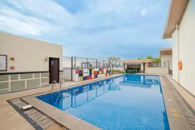 a swimming pool on the side of a building at Modern Stylish Condo in Morgan Suites McKinley with Wi-Fi in Manila