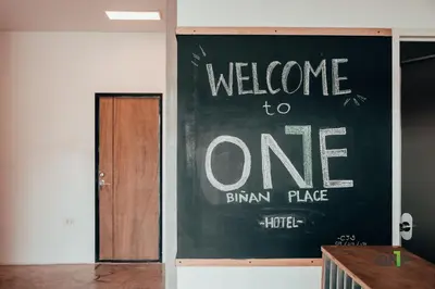 aelcome to one sign on a wall in a room at One Biñan Place in Biñan