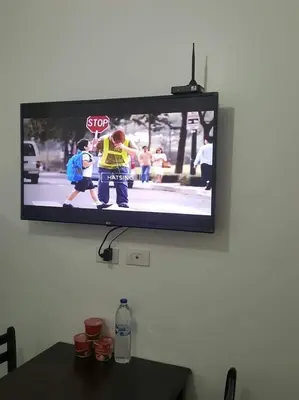 a television hanging on a wall with a stop sign at A SPECIAL PLACE Shore Residences in Manila