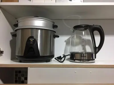 a slow cooker and a tea kettle on a shelf at A SPECIAL PLACE Shore Residences in Manila