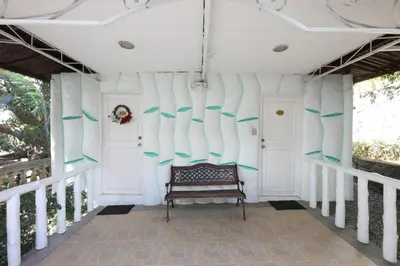 a porch with surfboards on the wall at Loreland Farm Resort in Antipolo