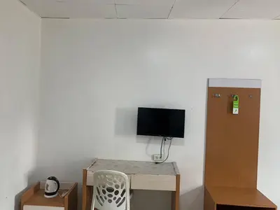 a room with a desk with a tv and a chair at Lucky Hotel Binondo in Manila