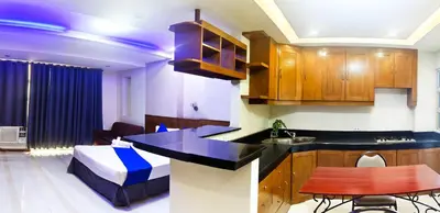 a room with a kitchen and a living room at Alley 8 Makati in Manila