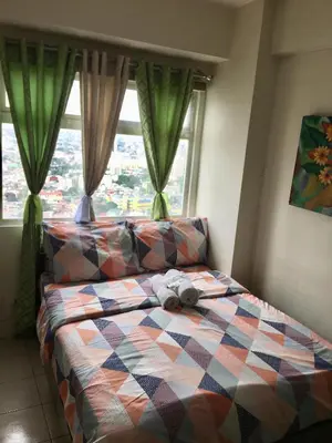 a bed with a stuffed animal on it in a bedroom at Booker Com in Mandaluyong in Manila