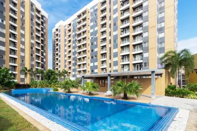 an image of a swimming pool in front of buildings at 1BR Interiored Condo with WiFi, Netflix, Hot Shower - The Hive Residences in Taytay