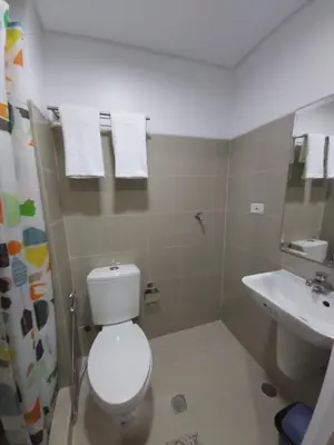 a bathroom with a toilet and a sink at Tower C Shore Residences by CSLUXE in Manila