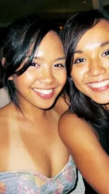 two young women are posing for a picture at Makati CBD Resort 2 bedroom in Manila