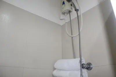 a bathroom with a shower with a towel at Chateau Elysee a14 near Airport Wifi Kitchen in Manila