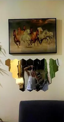 a person taking a picture of horses in a painting at A Refreshing Condo Unit Near BGC, Ortigas & Makati with NETFLIX and WiFi in Manila