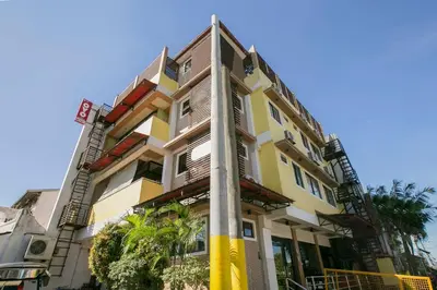 a yellow building with a pole in front of it at Rjat Guesthouse in Biñan