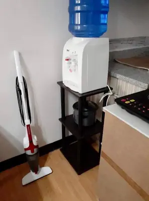 a microwave on a stand with a bucket on top of it at Estien’s cozy condo to stay with kitchen in Manila