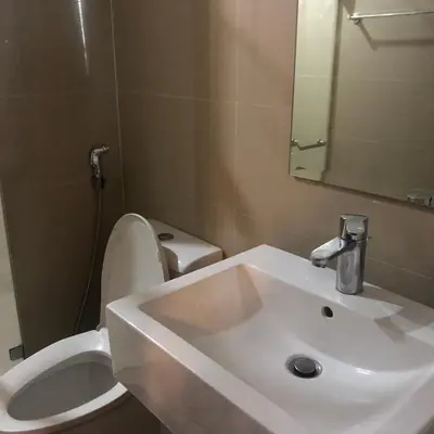a bathroom with a white sink and a toilet at Favila Condotel unit in Palmtree Villas Newport City walking distance to Airport terminal 3 Accessable to Airport terminal 1 &2 in Manila