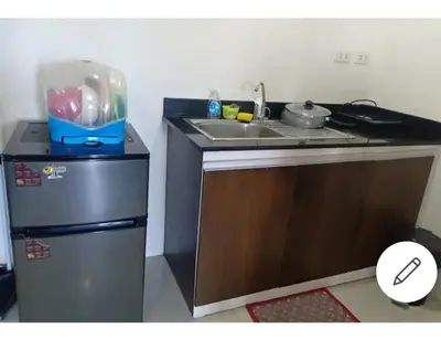 a small kitchen with a sink and a refrigerator at Mhavic family room ,group friend good for 6 guest in Manila