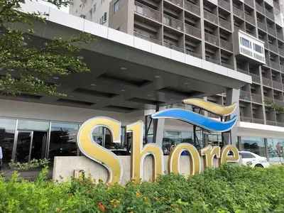 a sign for a store in front of a building at Sithonia Suite, Shore Residences Tower C near MOA in Manila