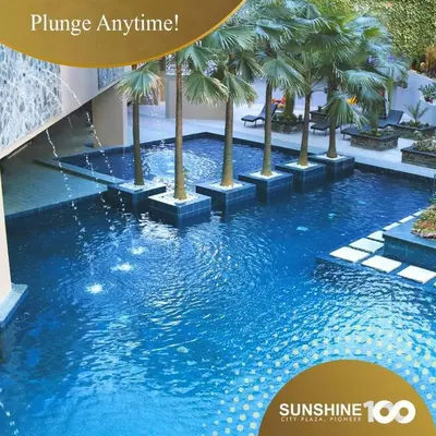 a swimming pool with palm trees in a building at U607 Sunshine100 Netflix 65InchesTV Wifi Karaoke Swimming Pool in Manila
