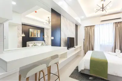 a bedroom with a bed and a large mirror at Elegant Living at Grace Residences T3-2206 Taguig-Steps from SM Aura and BGC in Manila