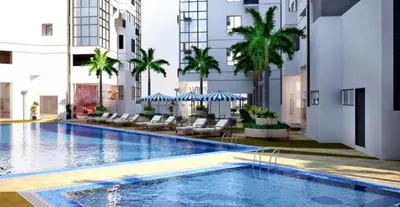 a large swimming pool in the middle of a building at BGC Fort Victoria in Manila