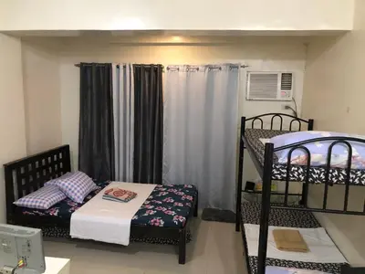 a small room with two bunk beds in it at Your City•Home Apartment in Manila