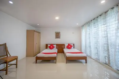 a hospital room with two beds and a window at OYO 588 Sunrock Resort in Antipolo