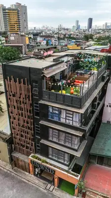 a building with a garden on the top of it at UNWND Boutique Hotel Makati in Manila