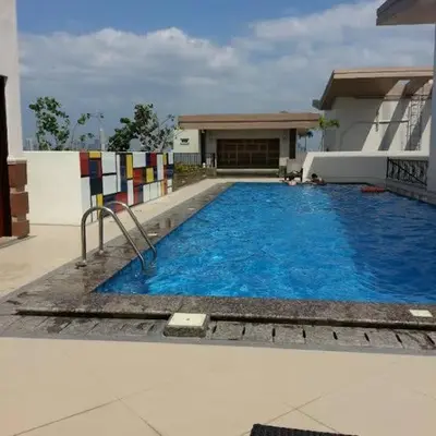 a large blue swimming pool in front of a building at Morgan Suite BGC shortwalk4 Venice Canal Mall free pool gym in Manila