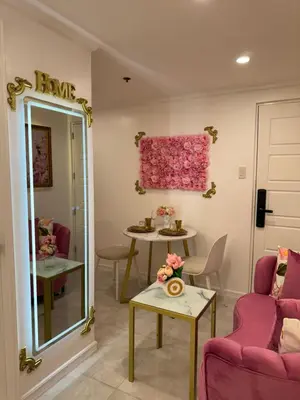 a living room with a table and a pink window at MAKATI Isabela Luxury in Manila