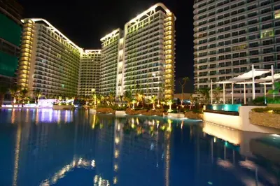a large pool of water in front of tall buildings at Azure Urban Resort Residence a4 near airport mall with wavepool in Manila