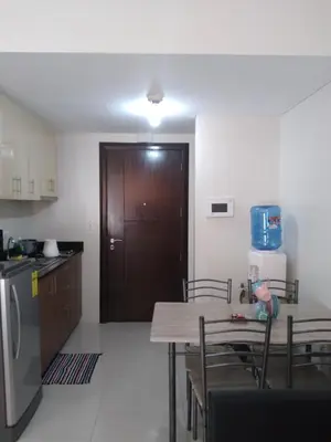 a kitchen with a table and a wooden door at One Palm Tree Villas-Terminal 3 Pasay Manila in Manila