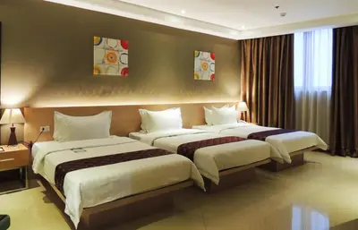 a hotel room with two beds in a room at Dela Chambre Hotel in Manila