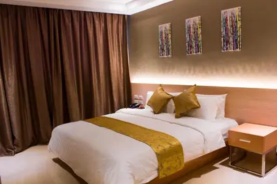 a bedroom with a large bed in a room at Dela Chambre Hotel in Manila