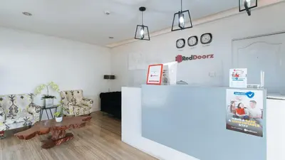 a living room with a counter and chairs at RedDoorz near SM Calamba in Laguna
