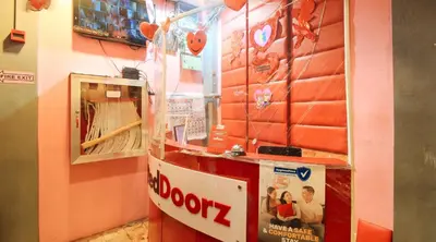 a room with a booth with a sign on the wall at RedDoorz @ P Florentino Street Sampaloc Manila in Manila