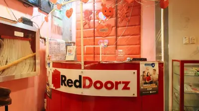 a red door refrigerator with a sign on it at RedDoorz @ P Florentino Street Sampaloc Manila in Manila