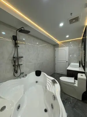 a bathroom with a white bath tub and a toilet at City View at MAKATI Prime Luxury in Manila