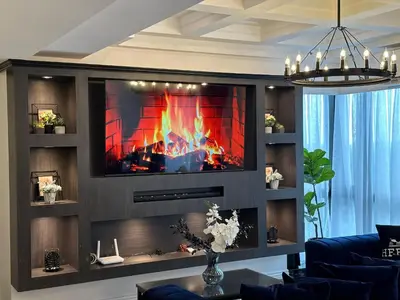 a fireplace in a living room with a tv at City View at MAKATI Prime Luxury in Manila