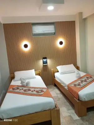 two beds in a hotel room with two at Airport Hostel Manila in Manila