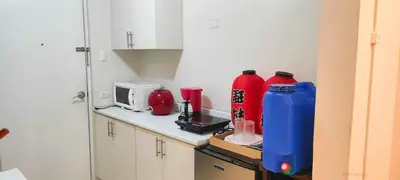 a kitchen with two red bottles on a counter at Centropolis King Bed Deluxe in Manila