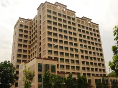 a large white building with a lot of windows at Alabang Condotel in Studio One Condominium in Manila