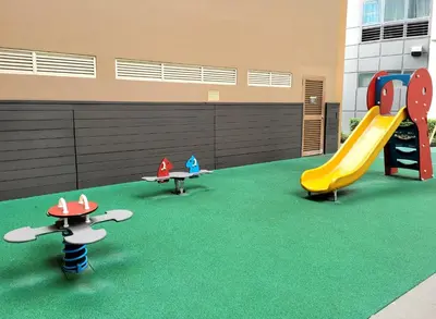 a play area with three slides and a playground at Andy's Place One Eastwood Tower 1 in Manila