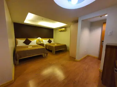 a living room with a couch and a table at Festive Hotel Makati in Manila