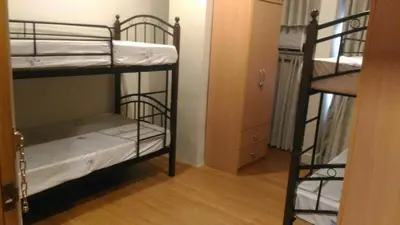 a room with two bunk beds and a closet at 538 Dormitel in Manila